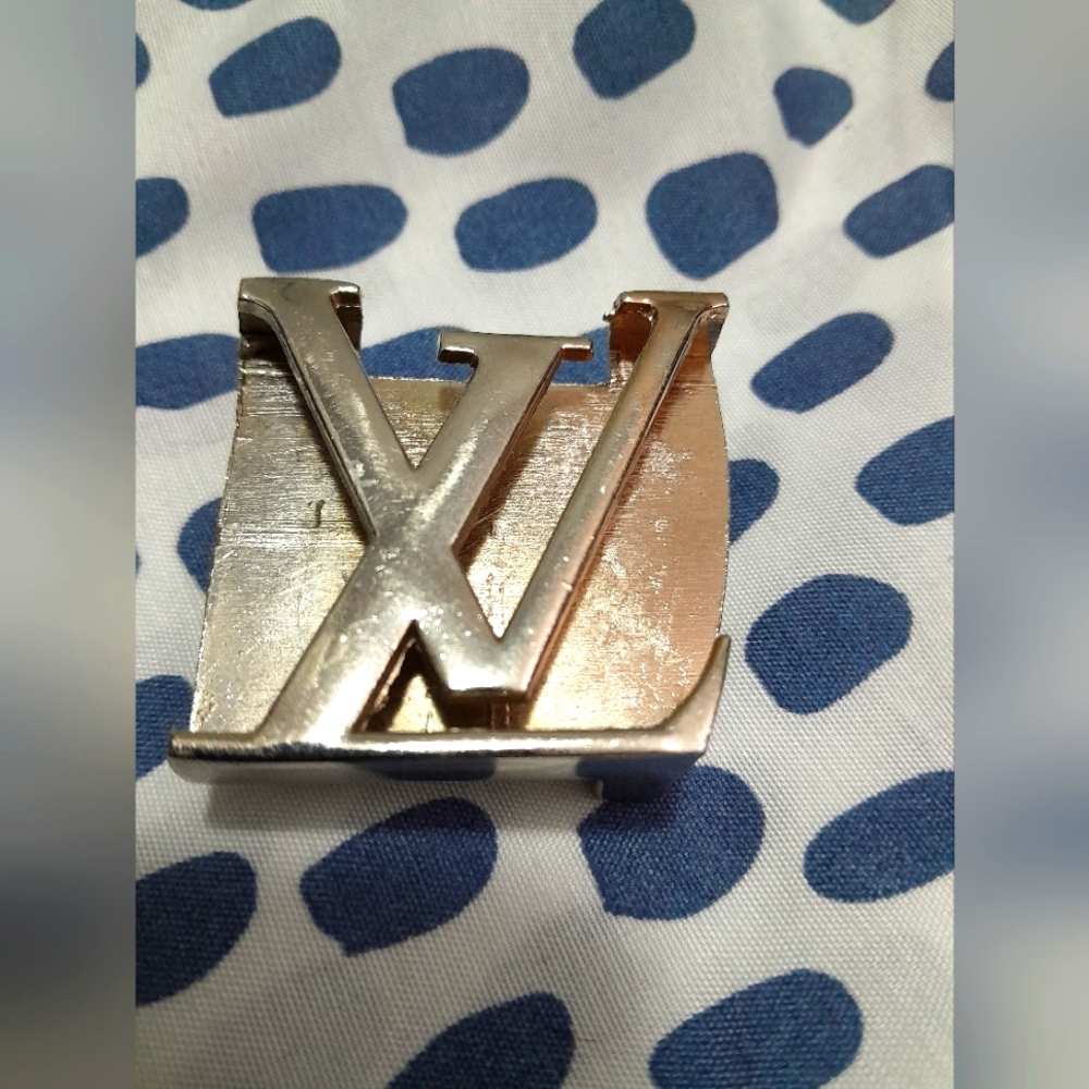 Louis Vuitton belt buckle. (Costume)